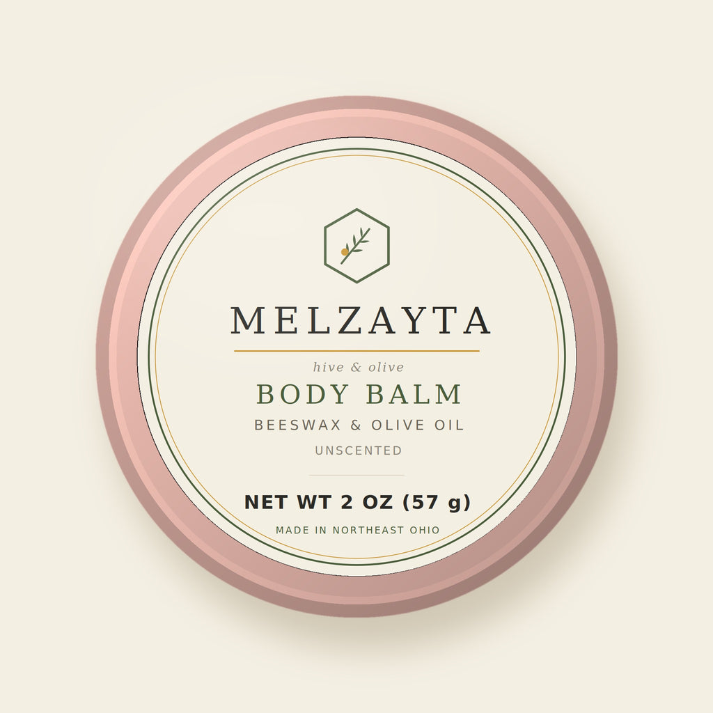 Melzayta Body Balm: closed rose-gold tin with the cream Body Balm label, beeswax and olive oil, 2 oz